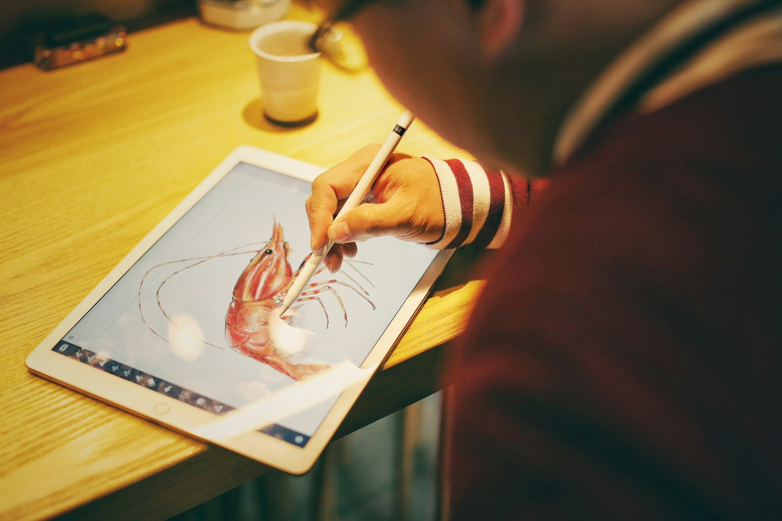 Child designing on a tablet in a Canva workshop