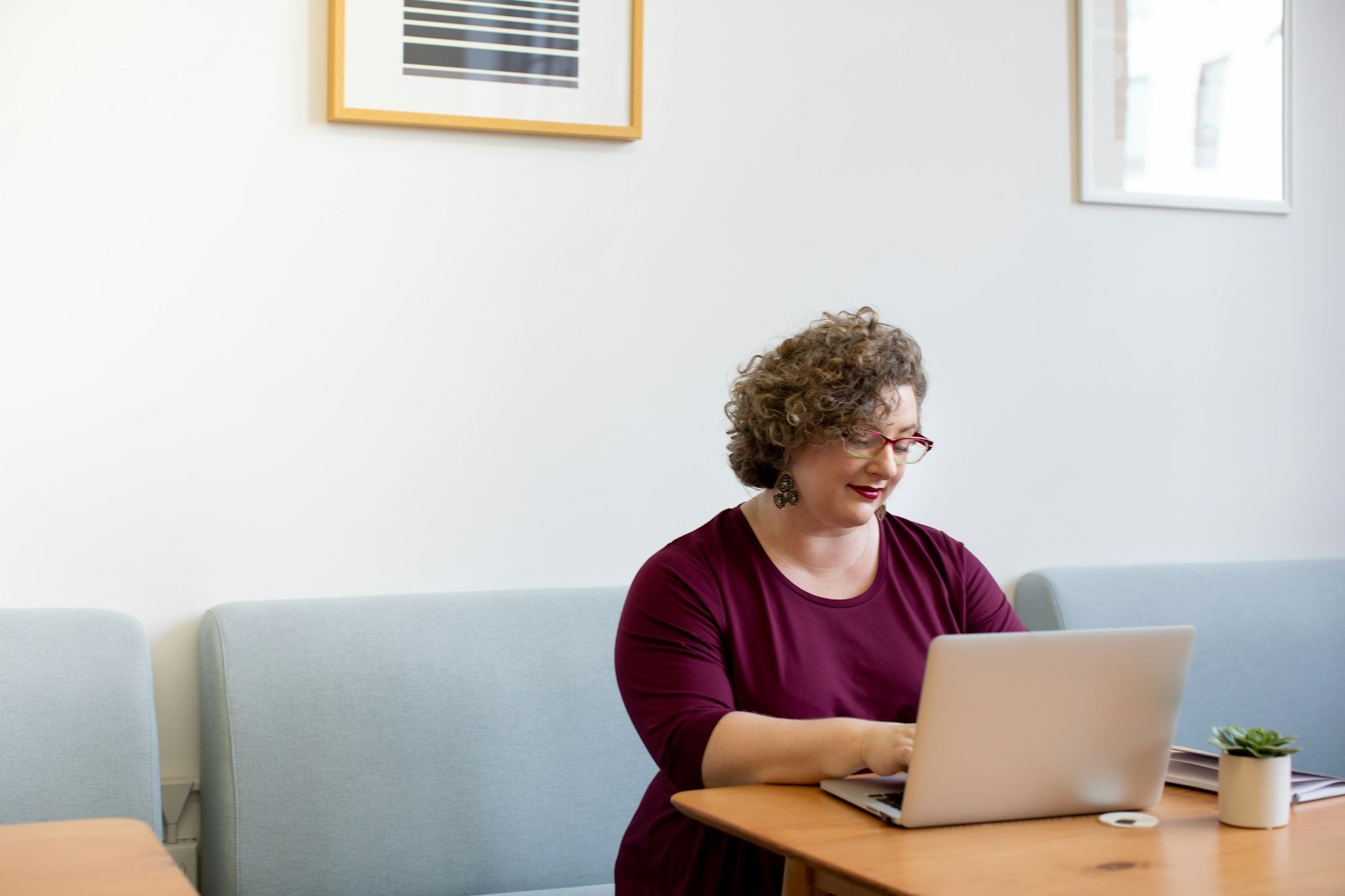 Woman learning Canva on a laptop
